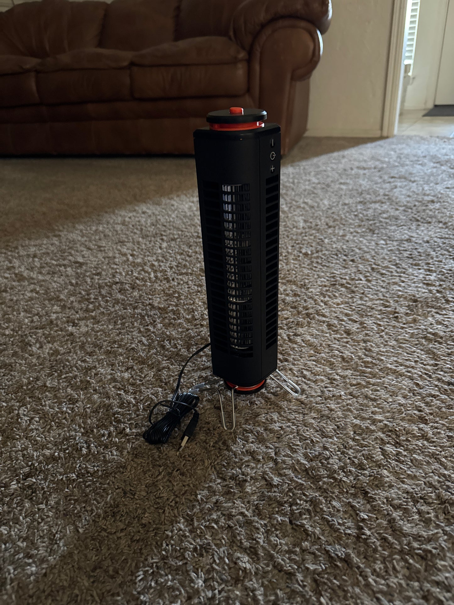 Portable USB powered tower fan with easy touch controls, ability to use standing up or lying flat, swivel base, and small size for travel