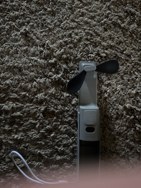 Portable power bank charger with built-in 2-speed fan and flashlight. Keep yourself cool this summer and stay charged up at the same time. All from this little handy gadget that will fit in your pocket
