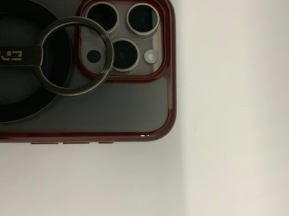 Be My AI: The picture shows a close-up of a few objects. On the left side, there is a black circular object with a handle. The handle has the letters "E3" on it. The circular object seems to be resting on a larger black surface.

On the right side, there is a part of a device with a red border. It appears to be the corner of a smartphone or a tablet with a camera. The camera section has three circular lenses and a flash, all enclosed in a square with rounded corners.

The background is plain white.