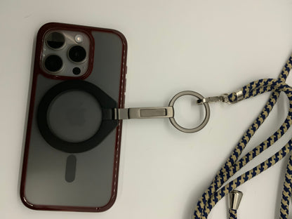 Be My AI: The picture shows an iPhone with a red case. The case has a circular cutout in the middle where the Apple logo on the back of the phone is visible. Above this cutout, there are three camera lenses in a triangular configuration, along with a flash.

Attached to the case is a silver keyring with a black circular attachment. The keyring is connected to a lanyard that has a blue and yellow braided design. The lanyard appears to be made of fabric and has a silver clip at the end.