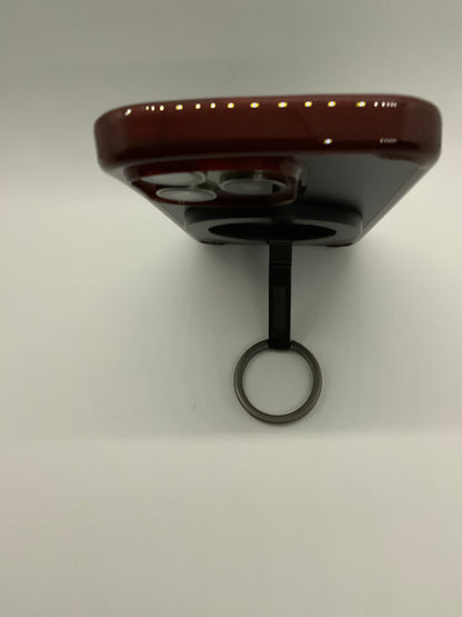 Be My AI: The picture shows an object that appears to be a small electronic device. It has a maroon-colored top with a row of tiny lights or sensors along the edge. Below the maroon top, there is a black section with two circular openings, possibly speakers or vents. The device is attached to a black stem that ends with a metal ring, similar to a key ring. The background is plain white.