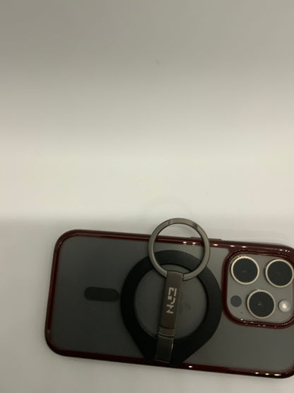 Be My AI: The picture shows a smartphone with a case on it. The case is transparent with a red border. On the back of the phone, there is a circular ring holder attached. The ring holder is black with a silver ring and has the letters "EIN" written on it. The phone has three camera lenses and a flash in a square configuration on the top left corner. The background of the picture is plain white.