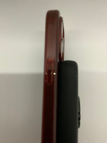 The picture shows two objects standing upright next to each other against a plain background. The object on the left is a dark red color and appears to be a thin rectangular shape with rounded edges. It has a clip on one side, similar to a pen's clip. The object on the right is black and has a similar shape but is slightly thicker. It also has a clip on one side. The picture is taken up close and the top of the objects are not visible.
