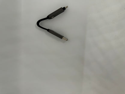 The picture shows a black cable on a white background. The cable appears to be short and has connectors on both ends. One end of the cable has a USB Type-C connector, while the other end has a micro USB connector. The cable is slightly curved in the middle.
