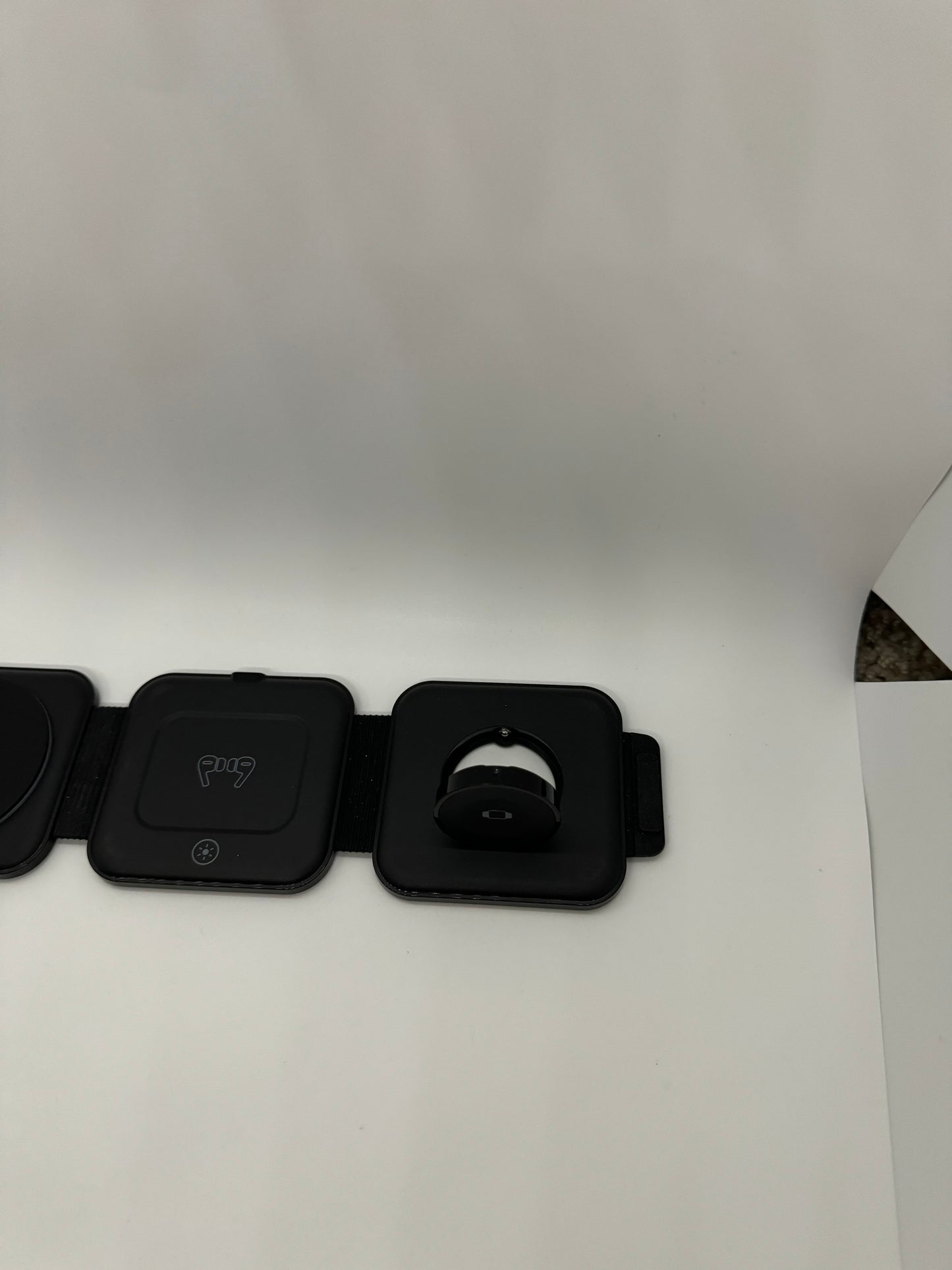 3 in 1 folding charging mat for Apple and other wireless devices. Includes wireless and MagSafe compatibility, place for wireless earbuds, and place for Apple watch. All in a small package that easily fits into a pocket or purse.