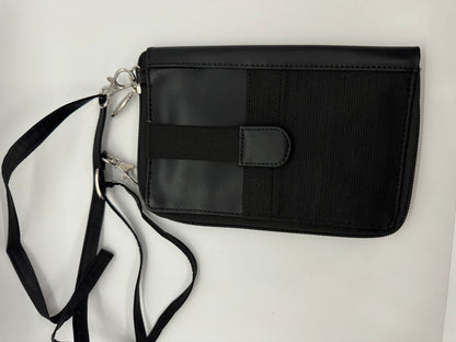 The picture shows a black wallet with a strap. The wallet appears to be made of a combination of smooth leather and a textured fabric. It has a flap on the front with a snap button for closure. There is also a zipper along the edge of the wallet. The strap is black and appears to be made of a fabric material. It is attached to the wallet with silver metal clasps. The background is plain white.